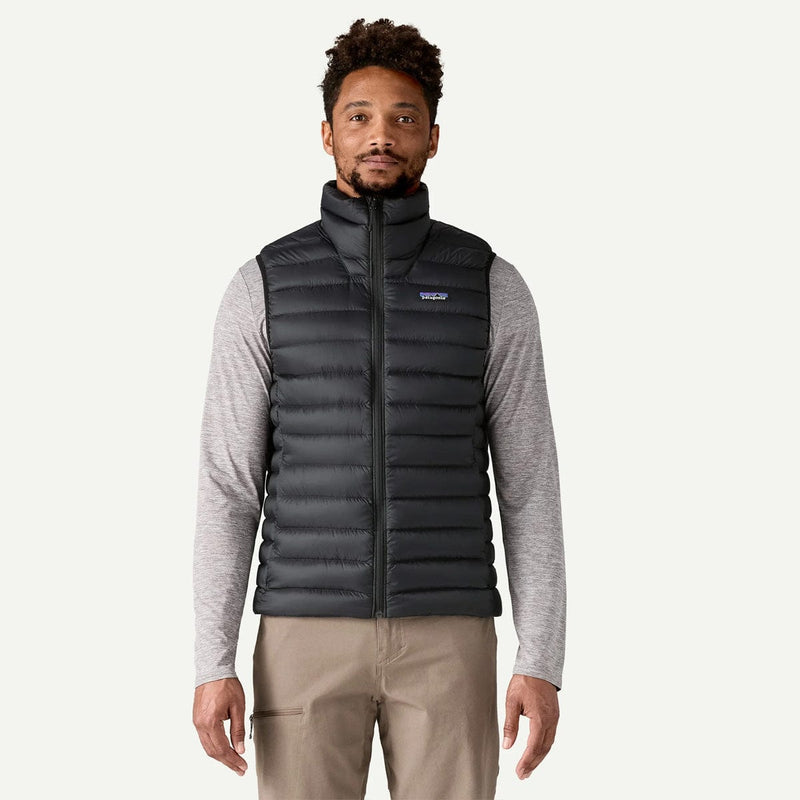 Load image into Gallery viewer, Man wearing a black puffer vest on a white background

