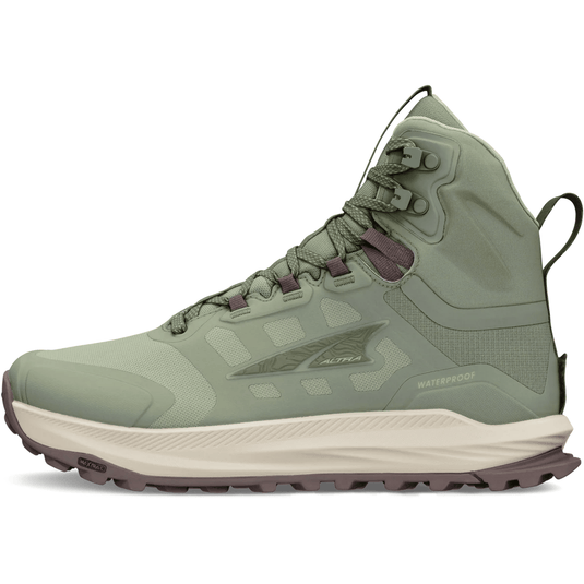 Green hiking boot with a white sole on a white background