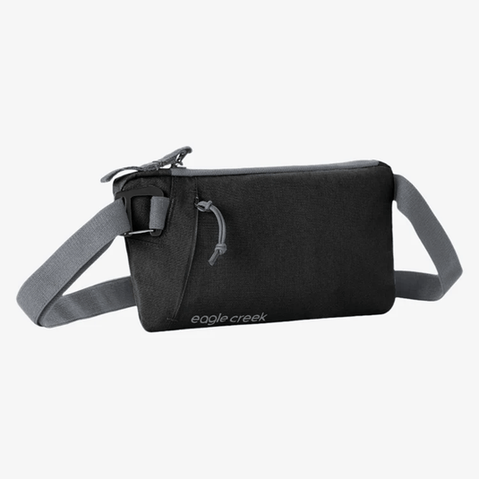 Black crossbody bag with gray strap on a white background, featuring 'eagle creek' branding.