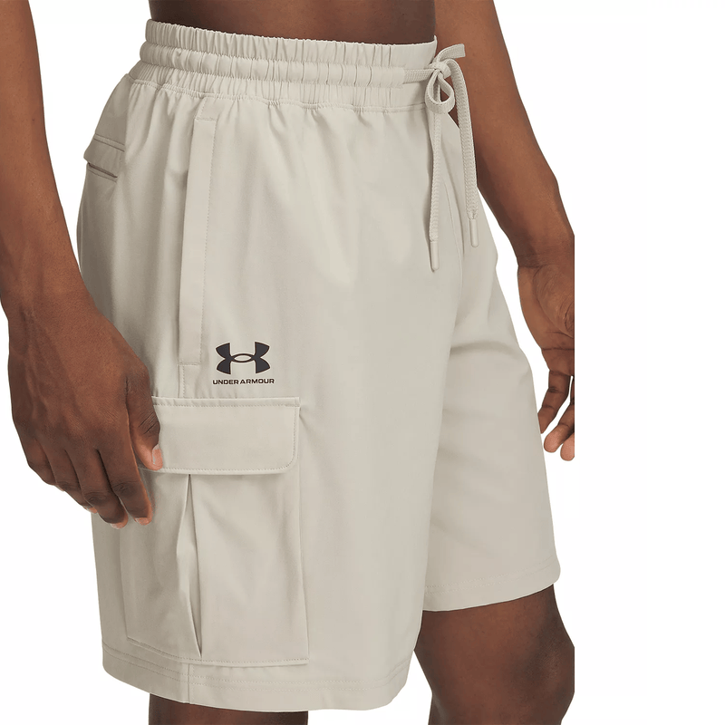 Load image into Gallery viewer, Beige shorts with Under Armour logo on a white background
