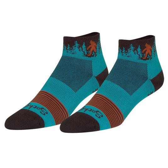 Pair of socks with a design of a bear and trees on a white background