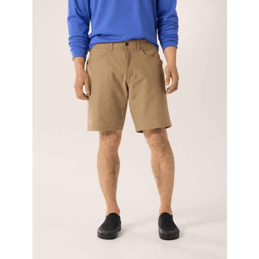 Person wearing beige shorts and a blue sweatshirt on a white background