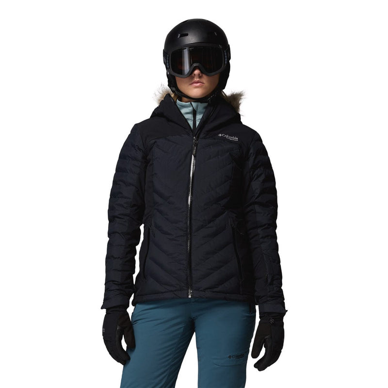 Load image into Gallery viewer, Person wearing a black winter jacket, helmet, and goggles on a white background
