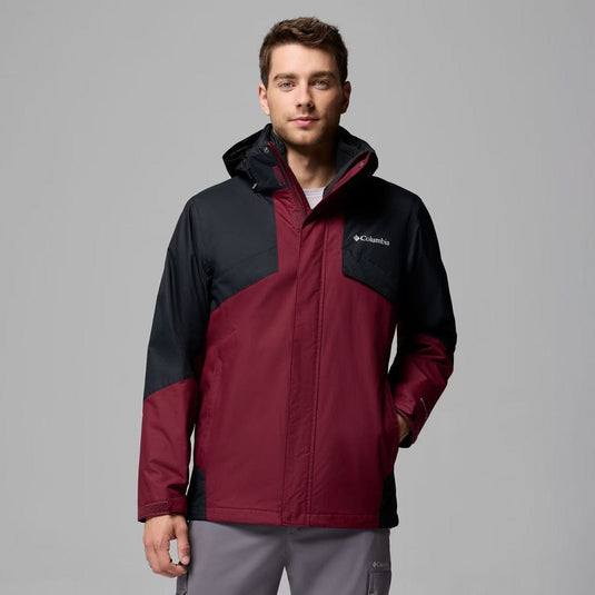 Man wearing a red and black Columbia jacket on a gray background