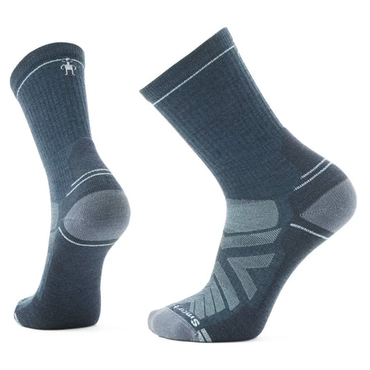 A pair of SmartWool Hike Light Cushion Crew socks in red and black, featuring a crew length and mesh zones on the side.