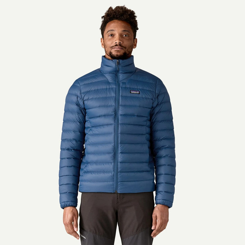 Load image into Gallery viewer, Man wearing a blue puffer jacket on a white background
