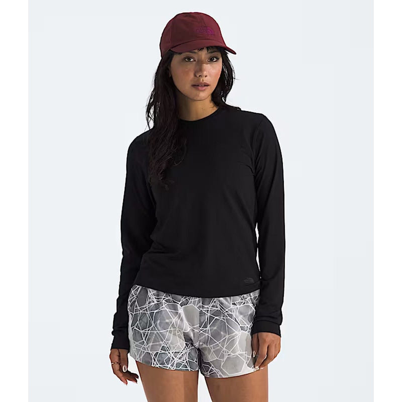 Load image into Gallery viewer, Woman wearing a black long-sleeve shirt, maroon cap, and patterned shorts on a white background
