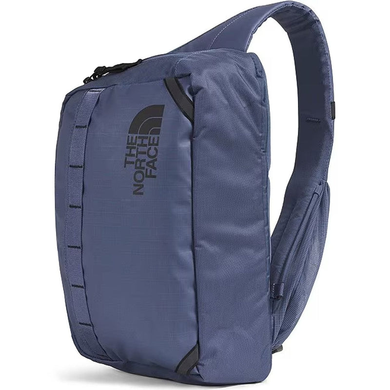 Load image into Gallery viewer, Blue sling bag with The North Face logo on a white background
