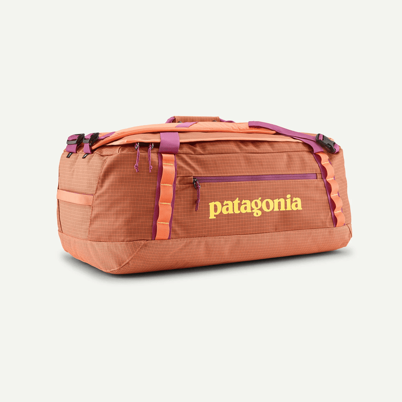 Load image into Gallery viewer, Orange duffel bag with Patagonia logo on a white background
