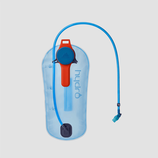 Hydration bladder with blue tube and red valve on a light gray background