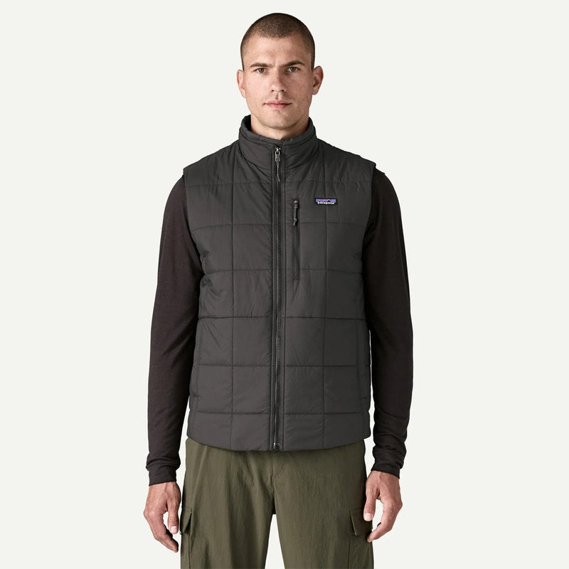 Load image into Gallery viewer, Man wearing a dark gray puffer vest with a brand logo on a white background
