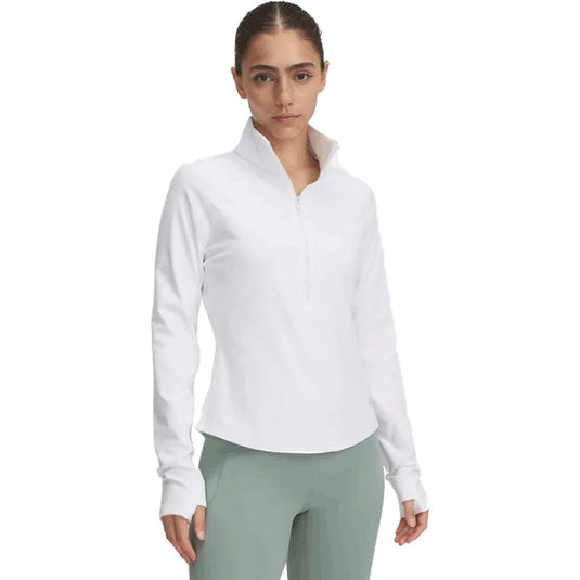Woman wearing a white long-sleeve shirt and green pants on a white background