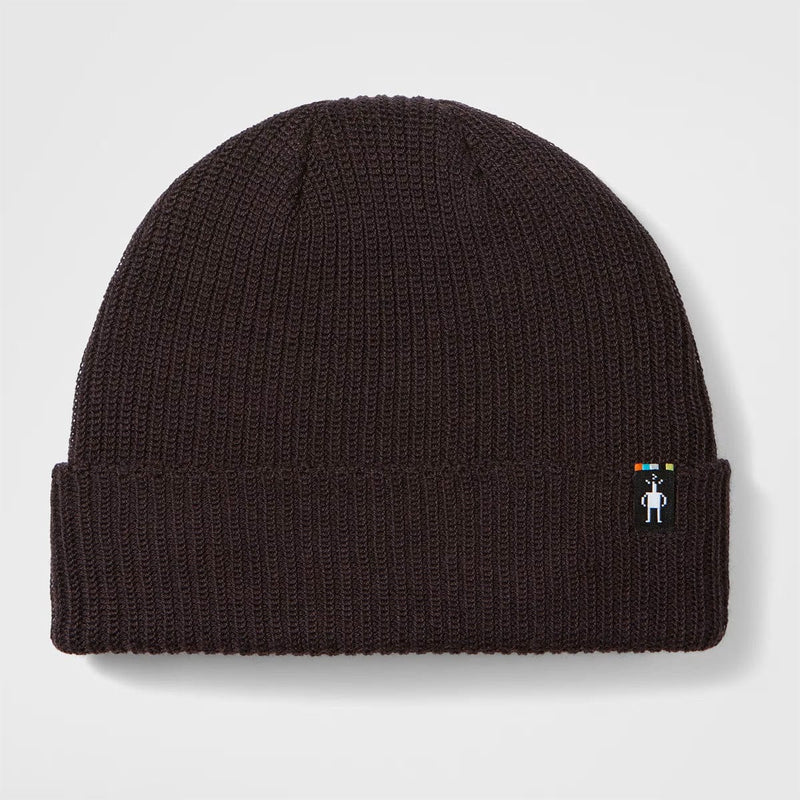 Load image into Gallery viewer, Black knit beanie with a small logo on a light gray background
