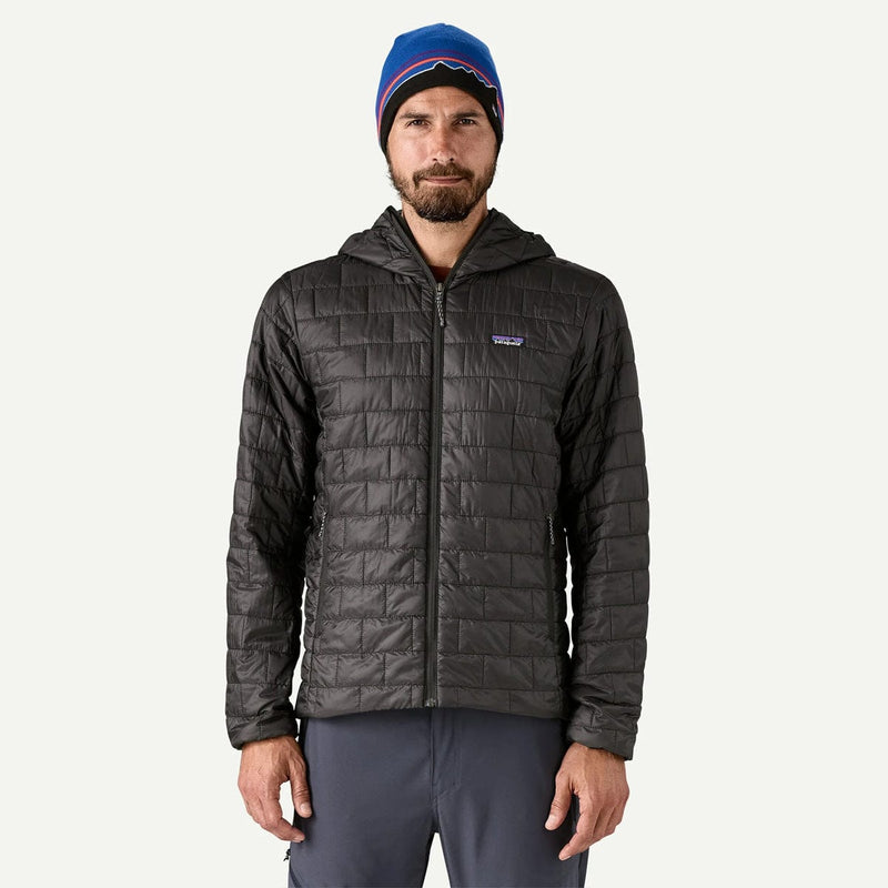 Load image into Gallery viewer, Man wearing a dark gray quilted jacket and blue beanie on a white background
