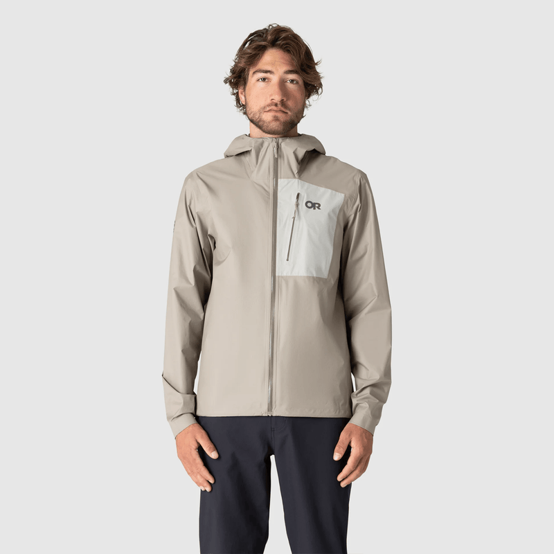 Load image into Gallery viewer, Man wearing a beige jacket with a brand logo on a light gray background

