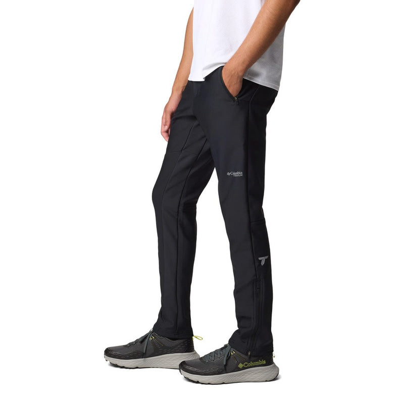Load image into Gallery viewer, Person wearing black pants with a visible brand logo on a white background
