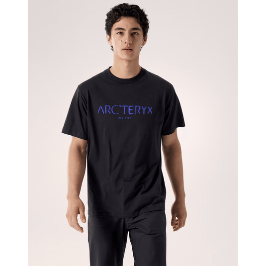 Person wearing a black t-shirt with 'Arc'teryx' logo on a plain background