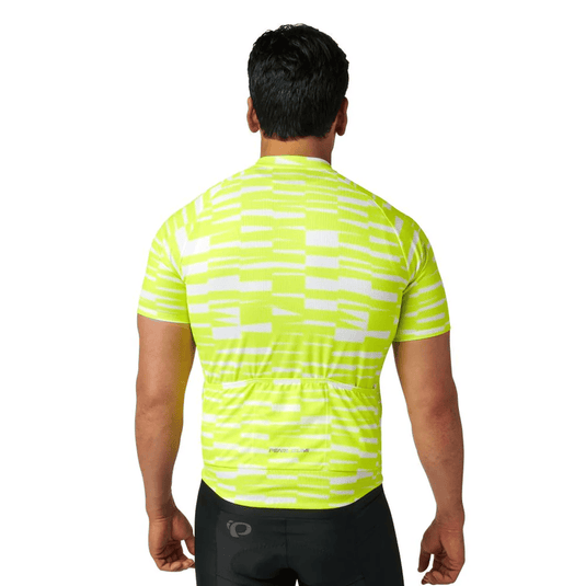 Person wearing a bright yellow cycling jersey with a subtle pattern on a white background
