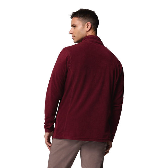 Man wearing a burgundy fleece jacket on a white background