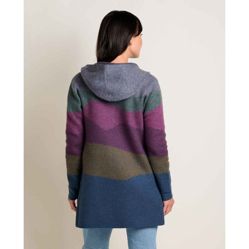 Load image into Gallery viewer, Person wearing a colorful striped coat on a plain background
