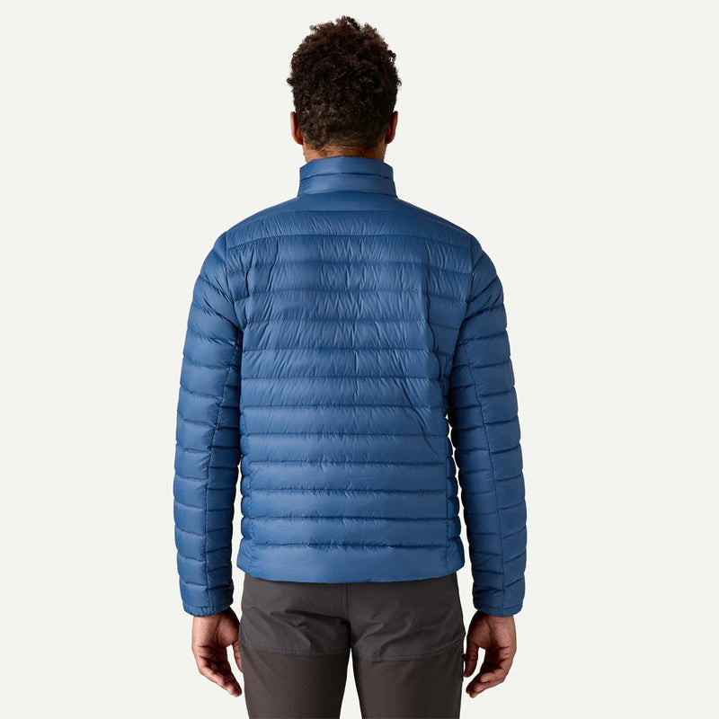 Load image into Gallery viewer, Person wearing a blue puffer jacket on a white background
