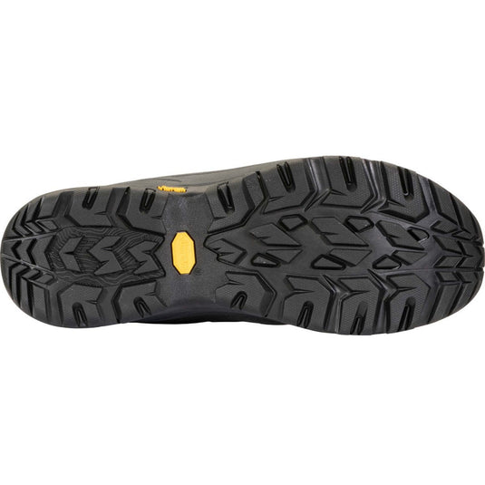 Close-up of a black shoe sole with a yellow label on a white background