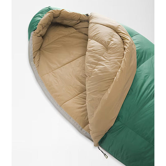 Green and beige sleeping bag on a white background