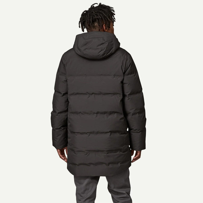 Load image into Gallery viewer, Person wearing a black puffer coat on a white background
