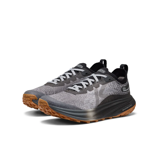 Gray and black running shoes with brown soles on a white background