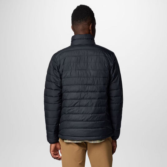 Person wearing a black puffer jacket on a white background