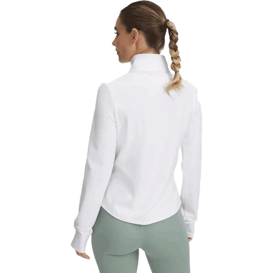 Woman wearing a white shirt and light green pants on a white background