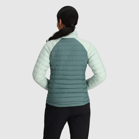Person wearing a two-tone green puffer jacket on a light gray background