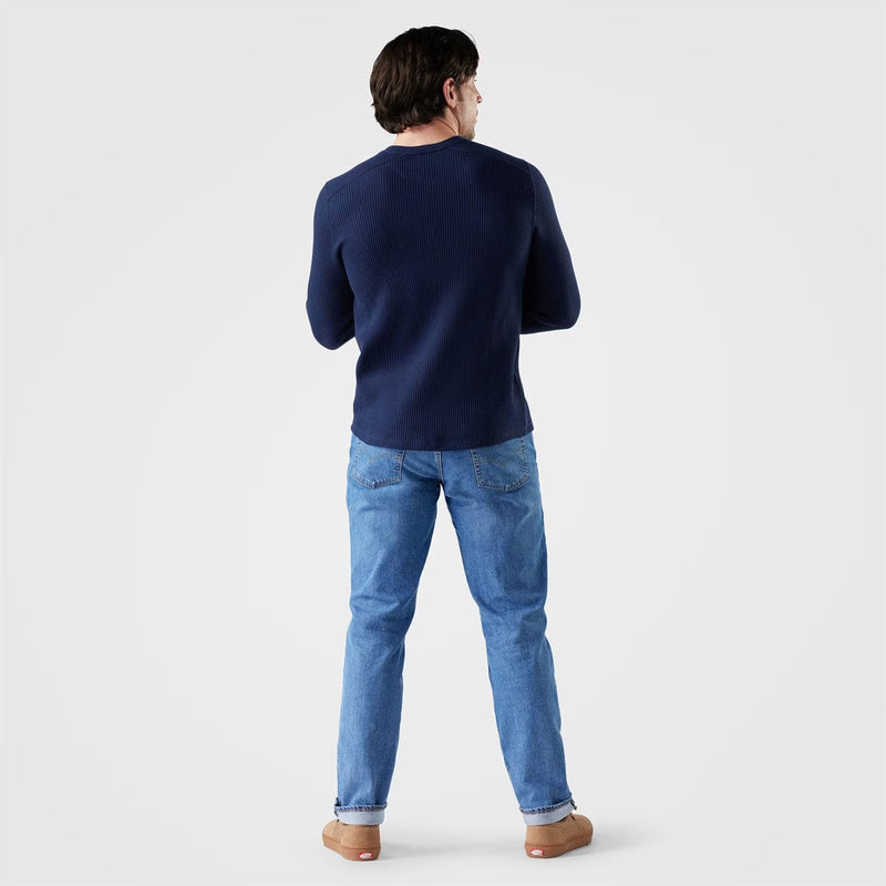 Load image into Gallery viewer, Person wearing a navy sweater and blue jeans on a light gray background
