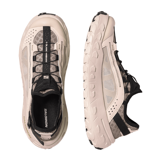 Beige and black running shoes with 'Salomon' branding on a white background