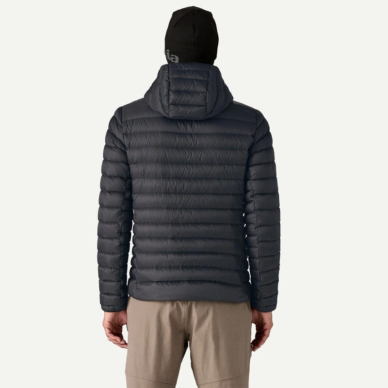 Load image into Gallery viewer, Person wearing a dark gray puffer jacket and beige pants on a white background
