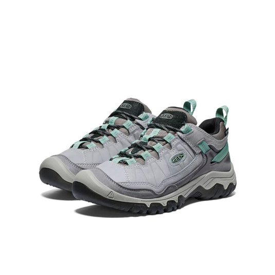 Pair of gray and teal hiking shoes on a white background