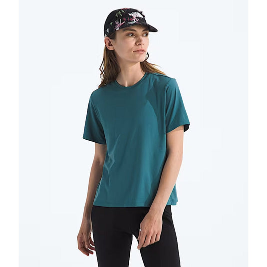 Woman wearing a teal t-shirt and black cap on a white background