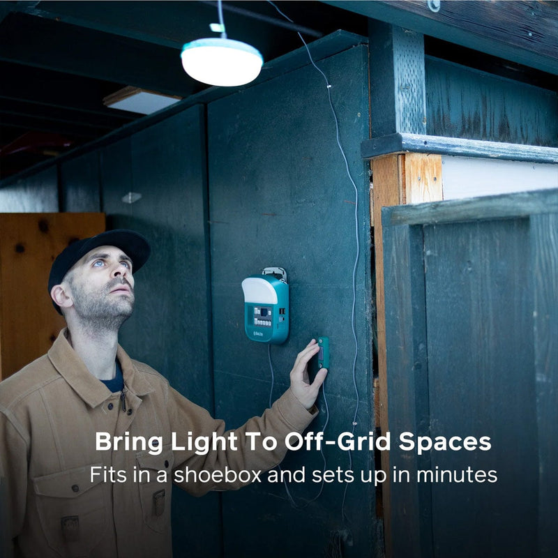 Load image into Gallery viewer, Person installing a small light fixture on a wall with text about off-grid lighting solutions.
