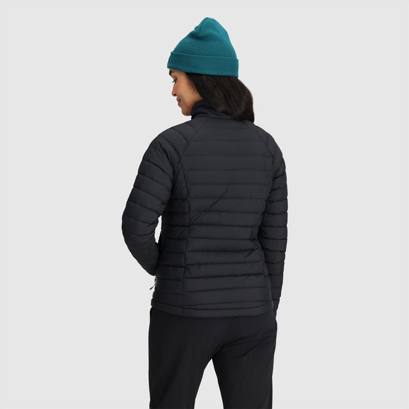 Load image into Gallery viewer, Person wearing a black puffer jacket and teal beanie on a light gray background
