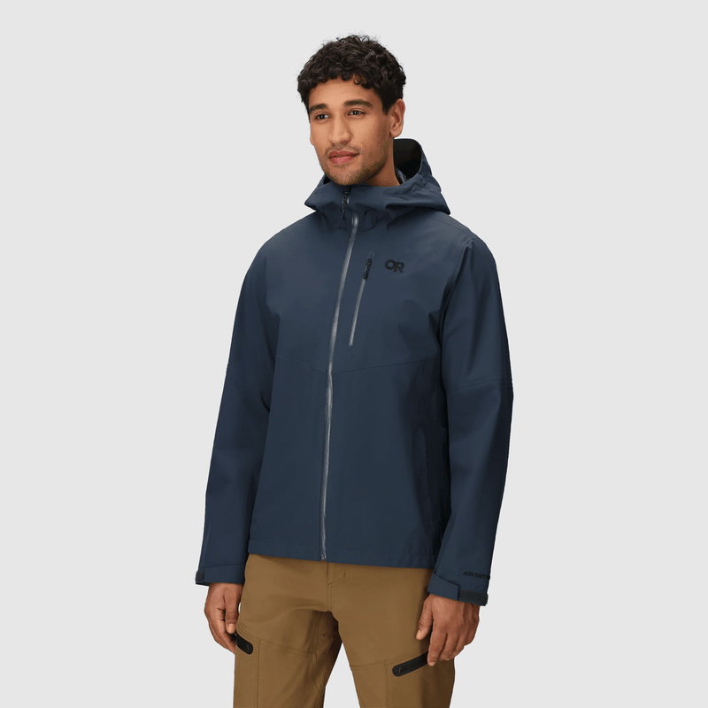 Load image into Gallery viewer, Man wearing a blue jacket with a brand logo on a light gray background
