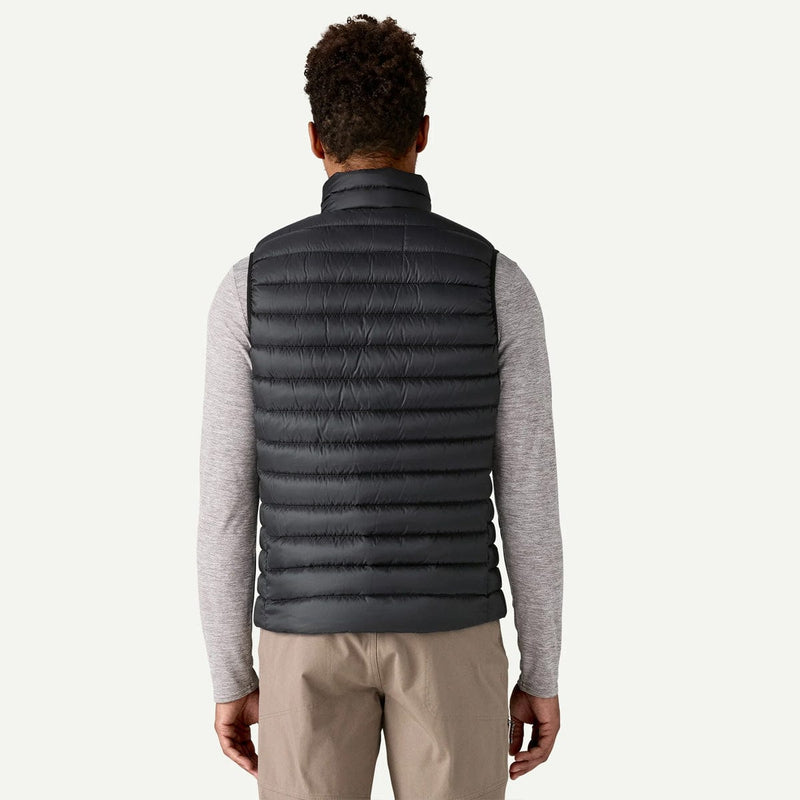 Load image into Gallery viewer, Person wearing a gray puffer vest over a light gray long-sleeve shirt on a white background
