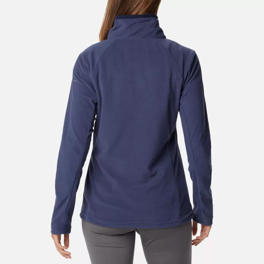A woman wearing a navy blue Columbia Glacial IV half zip fleece pullover with long sleeves.