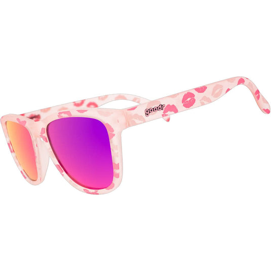 Pink sunglasses with floral pattern on arms and purple lens on white background