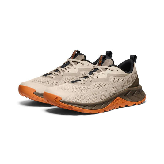 Beige and orange running shoes with 'Keen' branding on a white background