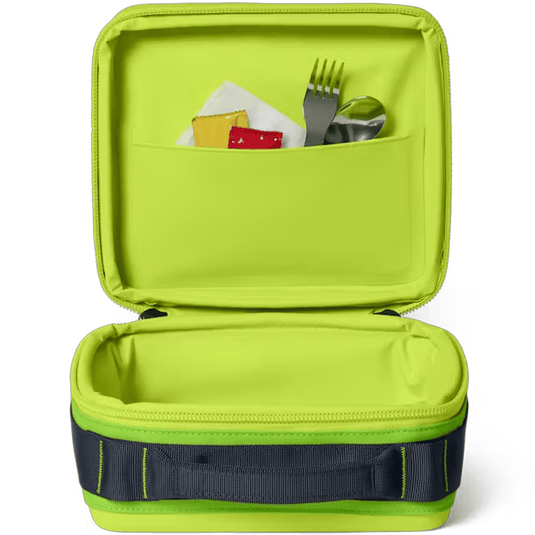 Green lunch box with compartments and utensils on a white background
