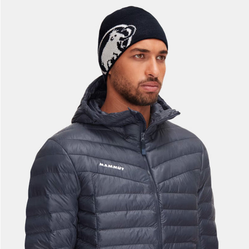Load image into Gallery viewer, Man wearing a dark gray puffer jacket with 'Mammut' branding and a black beanie with a bear design.
