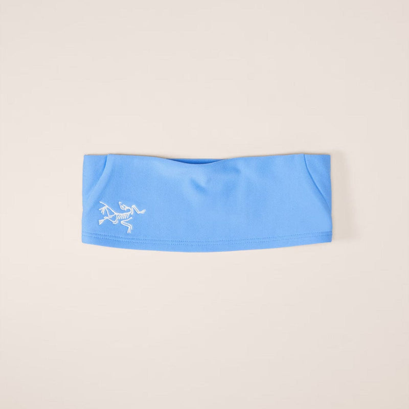 Load image into Gallery viewer, Blue headband with a logo on a beige background
