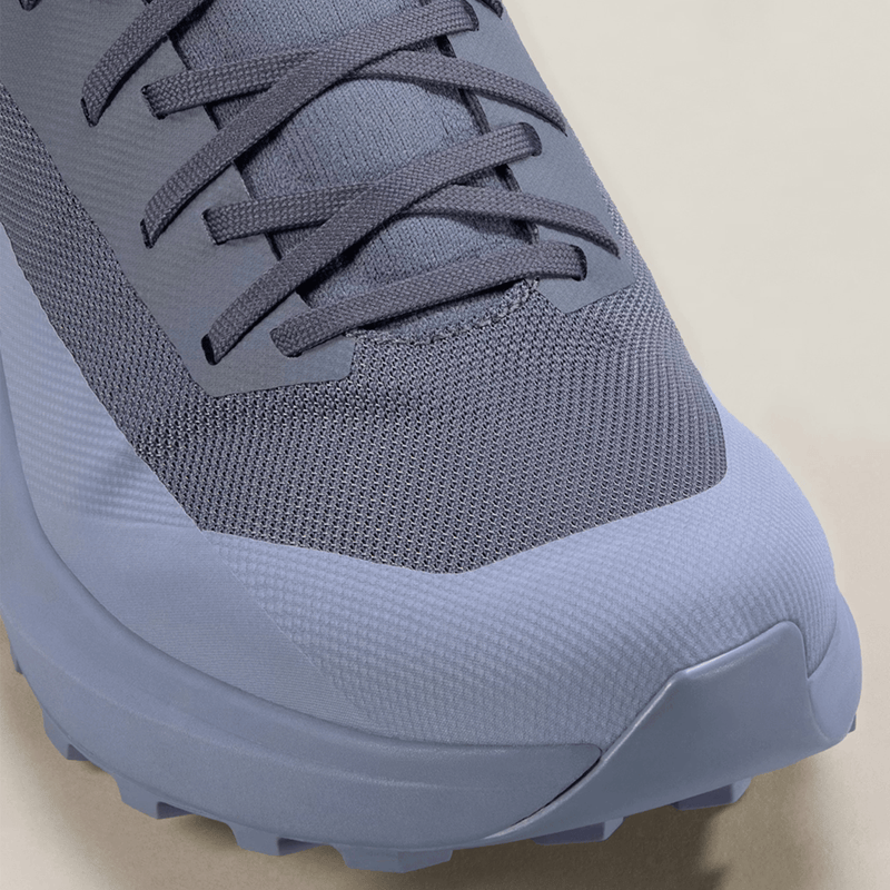 Load image into Gallery viewer, Close-up of a blue athletic shoe on a beige background
