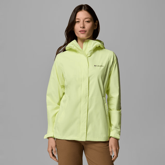 Woman wearing a light green Columbia jacket on a gray background