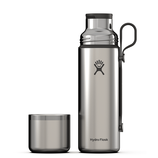 Hydro Flask stainless steel bottle with matching cup on a white background